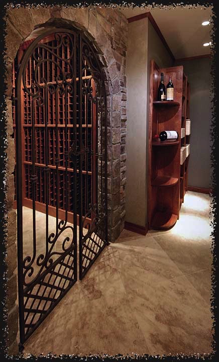 This L-shaped space has an outer room that store's cases with an endcap for display.  A decorative iron gate allows access to the inner room.